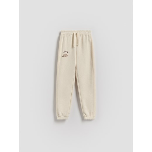 Reserved - Spodnie dresowe Pusheen - beżowy ze sklepu Reserved w kategorii Spodnie dziewczęce - zdjęcie 186701839