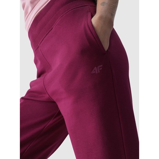 Damskie spodnie dresowe joggery 4F 4FWMM00TTROF0945 - różowe XS wyprzedaż Sportstylestory.com