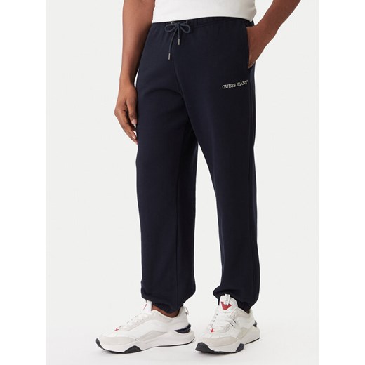 Guess Jeans Spodnie dresowe M6RB70 KCPR1 Granatowy Regular Fit ze sklepu MODIVO w kategorii Spodnie męskie - zdjęcie 187526346