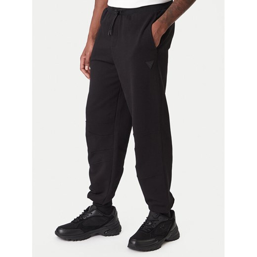 Guess Spodnie dresowe Z6RB03 K9YI1 Beżowy Regular Fit ze sklepu MODIVO w kategorii Spodnie męskie - zdjęcie 187623647