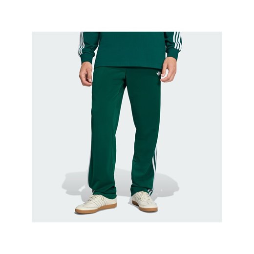 adidas Spodnie dresowe Firebird KD8317 Zielony Loose Fit ze sklepu MODIVO w kategorii Spodnie męskie - zdjęcie 187670246