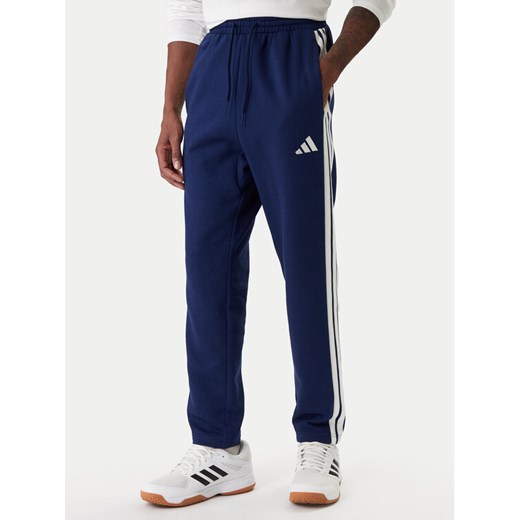 adidas Spodnie dresowe Essentials 3-Stripes JE6334 Granatowy Regular Fit ze sklepu MODIVO w kategorii Spodnie męskie - zdjęcie 187831008