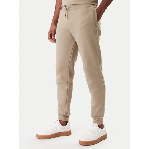 Guess Spodnie dresowe Z2YB22 K9V31 Beżowy Regular Fit ze sklepu MODIVO w kategorii Spodnie męskie - zdjęcie 187976166