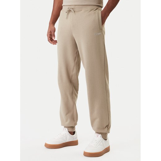 Guess Spodnie dresowe Z6RB12 KAIJ1 Beżowy Regular Fit ze sklepu MODIVO w kategorii Spodnie męskie - zdjęcie 188005647