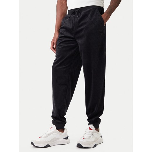 Guess Spodnie dresowe Z6RB14 KD612 Czarny Regular Fit ze sklepu MODIVO w kategorii Spodnie męskie - zdjęcie 188081365