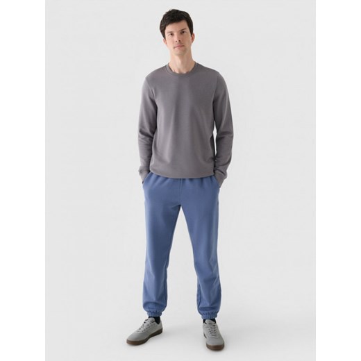 Męskie spodnie dresowe joggery 4F 4FWMM00TTROM1140 - niebieskie ze sklepu Sportstylestory.com w kategorii Spodnie męskie - zdjęcie 188477979