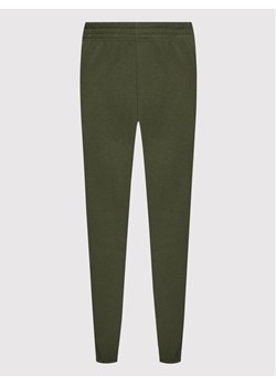 Nike Spodnie dresowe Sportswear Essential BV4089 Zielony Loose Fit ze sklepu MODIVO w kategorii Spodnie damskie - zdjęcie 134315595