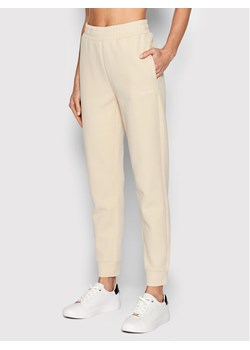 Calvin Klein Spodnie dresowe K20K204424 Beżowy Regular Fit ze sklepu MODIVO w kategorii Spodnie damskie - zdjęcie 150182037