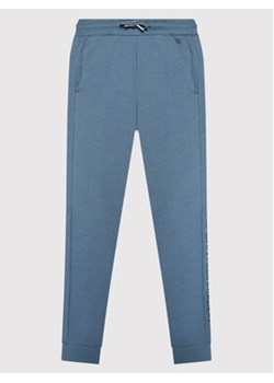 Calvin Klein Jeans Spodnie dresowe Institutional Spray IB0IB00922 Niebieski Regular Fit ze sklepu MODIVO w kategorii Spodnie chłopięce - zdjęcie 152503596