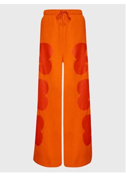 adidas Spodnie dresowe MARIMEKKO HH8751 Pomarańczowy Loose Fit ze sklepu MODIVO w kategorii Spodnie damskie - zdjęcie 152518975