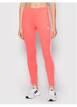 adidas Spodnie dresowe Primeblue Sst Track HF1994 Różowy Slim Fit ze sklepu MODIVO w kategorii Spodnie damskie - zdjęcie 152552678