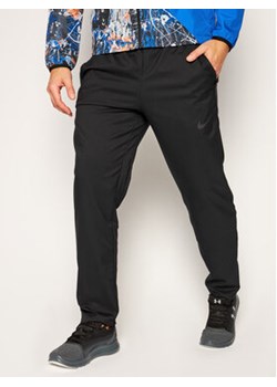 Nike Spodnie dresowe Dri-FIT CU4957 Czarny Standard Fit ze sklepu MODIVO w kategorii Spodnie męskie - zdjęcie 152687548