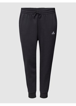 Spodnie dresowe PLUS SIZE z charakterystycznymi dla marki lampasami ze sklepu Peek&Cloppenburg  w kategorii Spodnie damskie - zdjęcie 160689608