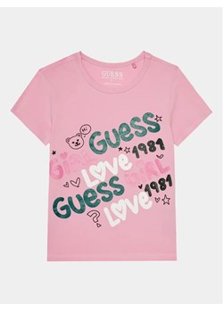 Guess T-Shirt K4RI03 K6YW4 Różowy Regular Fit ze sklepu MODIVO w kategorii Bluzki dziewczęce - zdjęcie 168384137