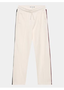 Tommy Hilfiger Spodnie dresowe KG0KG07407 D Écru Regular Fit ze sklepu MODIVO w kategorii Spodnie dziewczęce - zdjęcie 168411858