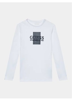 Guess Bluzka L3BI10 I3Z14 Biały Regular Fit ze sklepu MODIVO w kategorii T-shirty chłopięce - zdjęcie 168420036