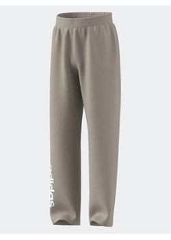 adidas Spodnie dresowe IB3234 Beżowy Loose Fit ze sklepu MODIVO w kategorii Spodnie chłopięce - zdjęcie 168432689