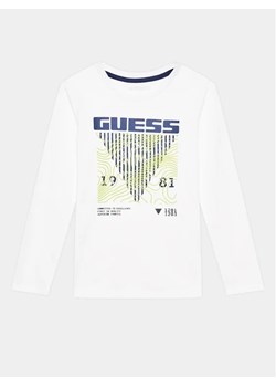 Guess Bluzka L3BI29 I3Z13 Biały Regular Fit ze sklepu MODIVO w kategorii T-shirty chłopięce - zdjęcie 168450567