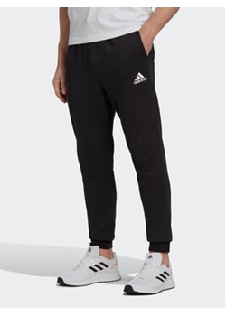adidas Spodnie dresowe Essentials Fleece Regular Tapered Joggers HL2236 Czarny Regular Fit ze sklepu MODIVO w kategorii Spodnie męskie - zdjęcie 168517996