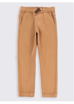 Coccodrillo Spodnie materiałowe ZC2119101BAB Beżowy Regular Fit ze sklepu MODIVO w kategorii Spodnie chłopięce - zdjęcie 168524098