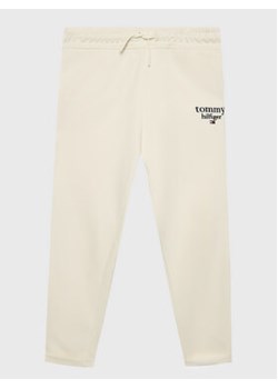 Tommy Hilfiger Spodnie dresowe Graphic KG0KG06866 M Écru Tapered Fit ze sklepu MODIVO w kategorii Spodnie chłopięce - zdjęcie 168530229