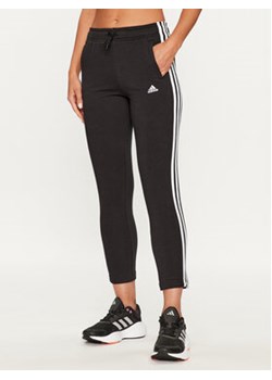 adidas Spodnie dresowe Essentials 3-Stripes IC6126 Czarny Slim Fit ze sklepu MODIVO w kategorii Spodnie dziewczęce - zdjęcie 168561215