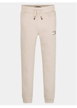 Tommy Hilfiger Spodnie dresowe KB0KB08475 M Beżowy Regular Fit ze sklepu MODIVO w kategorii Spodnie chłopięce - zdjęcie 168564917