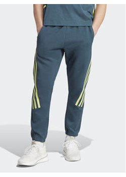 adidas Spodnie dresowe Future Icons 3-Stripes Joggers IJ6372 Turkusowy Slim Fit ze sklepu MODIVO w kategorii Spodnie męskie - zdjęcie 168576656