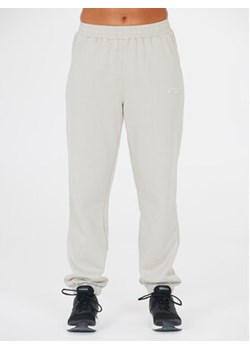 Athlecia Spodnie dresowe Asport W Pants EA233347 Beżowy Regular Fit ze sklepu MODIVO w kategorii Spodnie damskie - zdjęcie 168580147