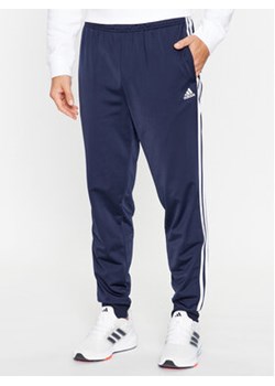 adidas Spodnie dresowe Essentials Warm-Up 3-Stripes H46106 Granatowy Regular Fit ze sklepu MODIVO w kategorii Spodnie męskie - zdjęcie 168596975