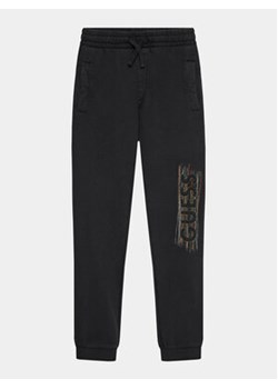 Guess Spodnie dresowe L3BQ12 KAD74 Czarny Relaxed Fit ze sklepu MODIVO w kategorii Spodnie chłopięce - zdjęcie 168607067