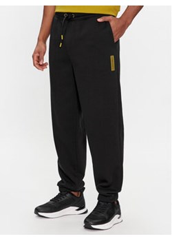 Calvin Klein Spodnie dresowe Grid Logo K10K112430 Czarny Relaxed Fit ze sklepu MODIVO w kategorii Spodnie męskie - zdjęcie 168644207