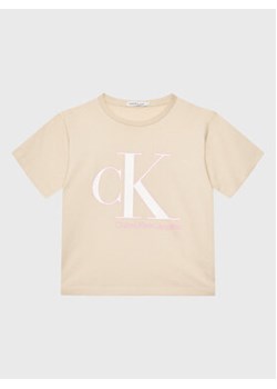 Calvin Klein Jeans T-Shirt Reveal Monogram IG0IG01939 Beżowy Regular Fit ze sklepu MODIVO w kategorii Bluzki dziewczęce - zdjęcie 168657828