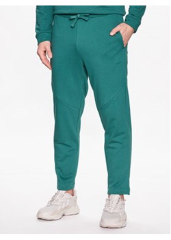 Outhorn Spodnie dresowe TTROM194 Zielony Regular Fit ze sklepu MODIVO w kategorii Spodnie męskie - zdjęcie 168662735