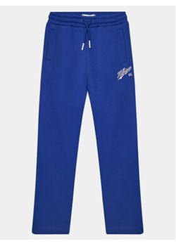 Tommy Hilfiger Spodnie dresowe Hilfiger Script Wide Sweatpant KG0KG07751 Niebieski Regular Fit ze sklepu MODIVO w kategorii Spodnie chłopięce - zdjęcie 168664479