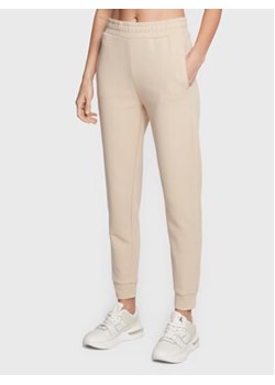 Calvin Klein Spodnie dresowe Micro Logo Essential K20K204424 Beżowy Regular Fit ze sklepu MODIVO w kategorii Spodnie damskie - zdjęcie 168674827