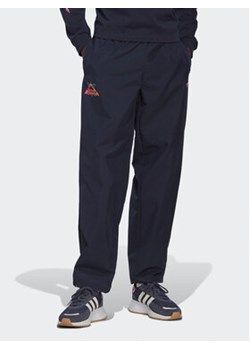 adidas Spodnie dresowe Adventure Ride HK4979 Granatowy Loose Fit ze sklepu MODIVO w kategorii Spodnie męskie - zdjęcie 169017527