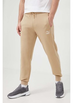 Puma spodnie dresowe kolor beżowy gładkie ze sklepu PRM w kategorii Spodnie męskie - zdjęcie 169246919
