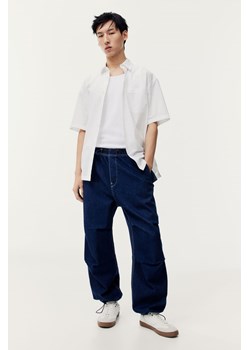 H & M - Spodnie spadochronowe Loose Fit - Niebieski ze sklepu H&M w kategorii Spodnie męskie - zdjęcie 169678918