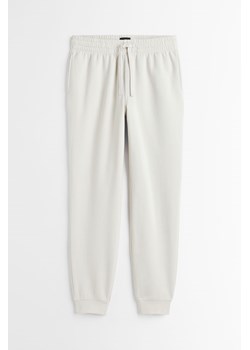H & M - Spodnie dresowe Regular Fit - Brązowy ze sklepu H&M w kategorii Spodnie męskie - zdjęcie 169681385