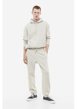 H & M - Spodnie dresowe Relaxed Fit - Brązowy ze sklepu H&M w kategorii Spodnie męskie - zdjęcie 169682446