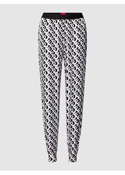 Spodnie materiałowe o luźnym kroju z nadrukiem z logo na całej powierzchni model ‘UNITE’ ze sklepu Peek&Cloppenburg  w kategorii Spodnie damskie - zdjęcie 169752019