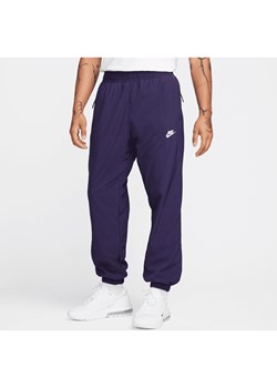 Męskie spodnie z tkaniny na zimę Nike Windrunner - Fiolet ze sklepu Nike poland w kategorii Spodnie męskie - zdjęcie 169755248
