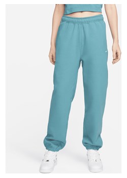 Damskie spodnie z dzianiny Nike Solo Swoosh - Niebieski ze sklepu Nike poland w kategorii Spodnie damskie - zdjęcie 169758847