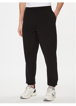 Calvin Klein Spodnie dresowe Embossed Logo K10K112198 Czarny Relaxed Fit ze sklepu MODIVO w kategorii Spodnie męskie - zdjęcie 169832879