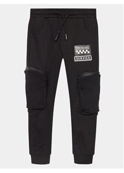 Coccodrillo Spodnie dresowe WC4120101RAK Czarny Slim Fit ze sklepu MODIVO w kategorii Spodnie chłopięce - zdjęcie 169842598