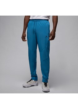 Męskie spodnie z tkaniny Jordan Dri-FIT Sport - Niebieski ze sklepu Nike poland w kategorii Spodnie męskie - zdjęcie 171247909