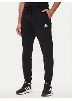adidas Spodnie dresowe Essentials Fleece Regular Tapered Joggers HL2236 Czarny Regular Fit ze sklepu MODIVO w kategorii Spodnie męskie - zdjęcie 171413246
