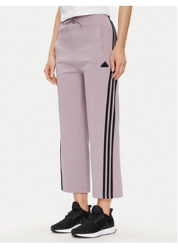 adidas Spodnie dresowe Future Icons 3-Stripes IS3661 Fioletowy Slim Fit ze sklepu MODIVO w kategorii Spodnie damskie - zdjęcie 171537856