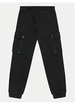 Coccodrillo Joggery WC4119101GBJ Czarny Slim Fit ze sklepu MODIVO w kategorii Spodnie chłopięce - zdjęcie 171707497